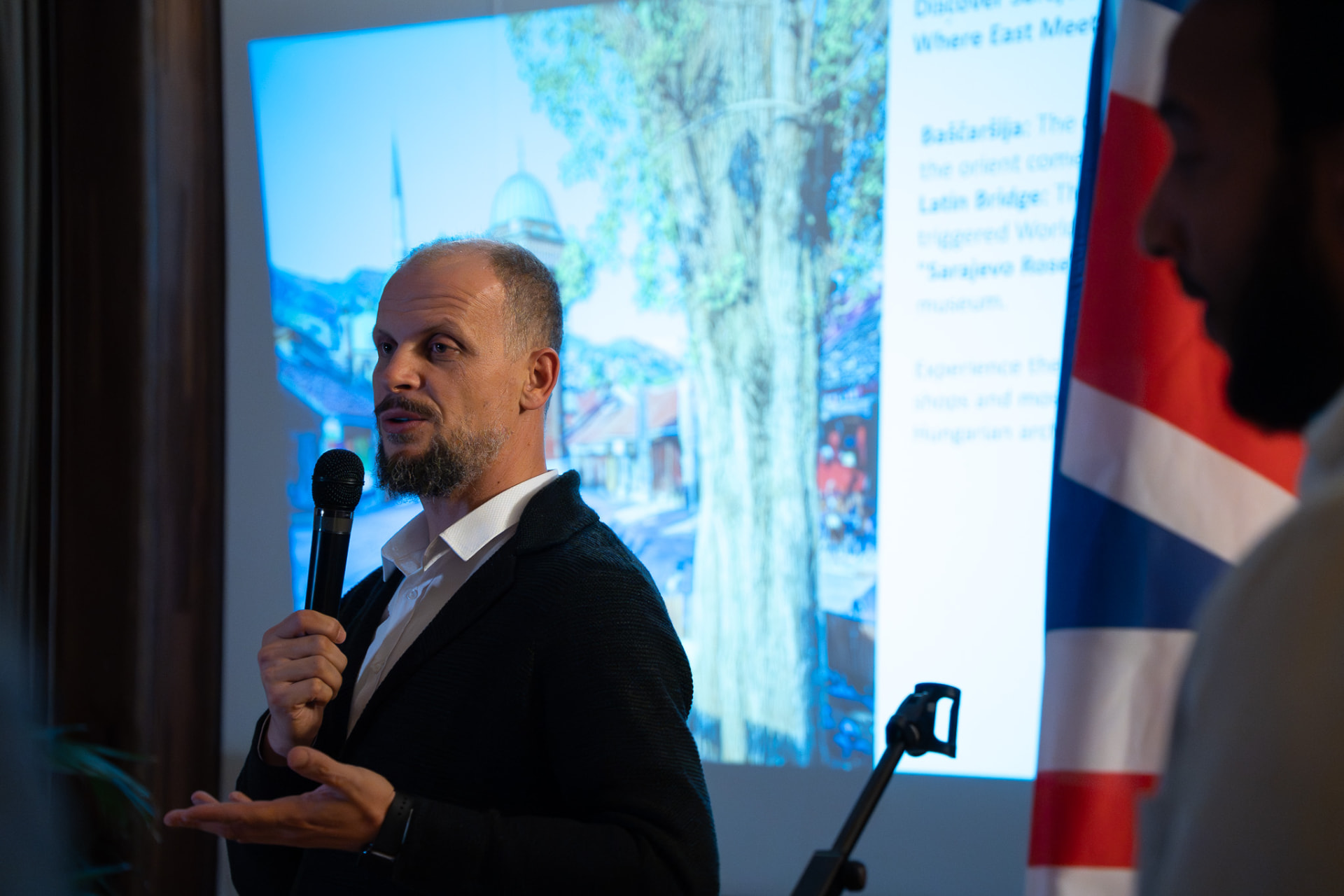 Hassan, founder of Just Tour, presenting Bosnia to guests in London